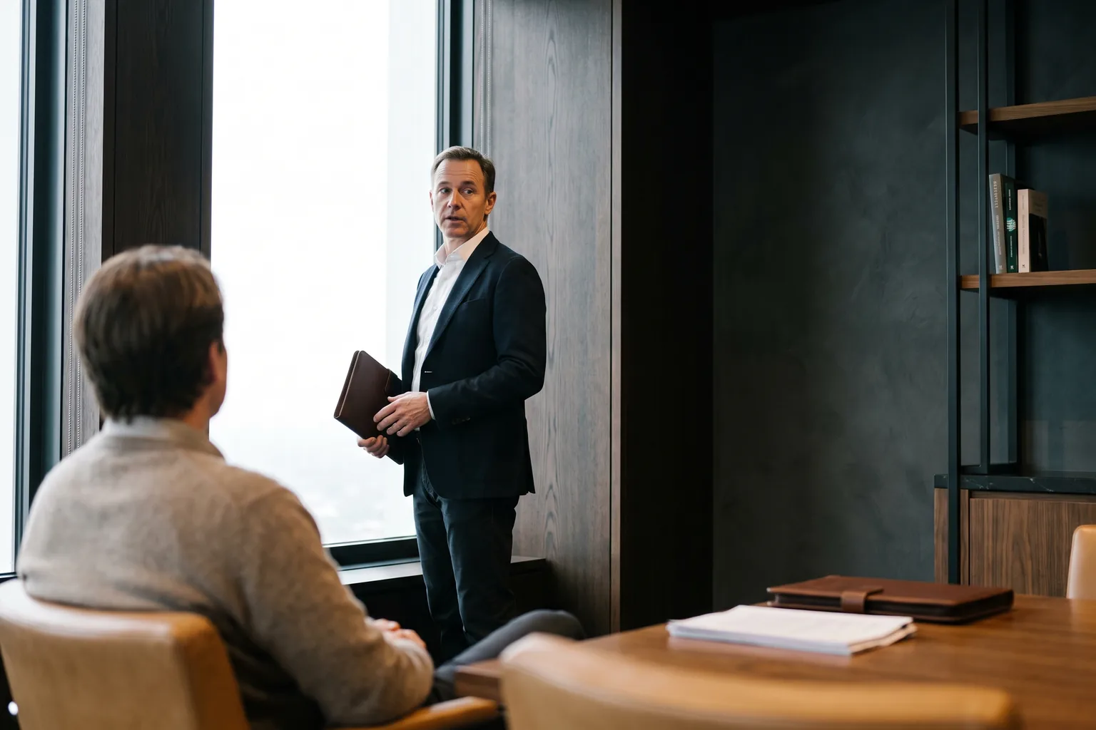 A decisive senior operator in a high-rise office at dusk, surveying with focus